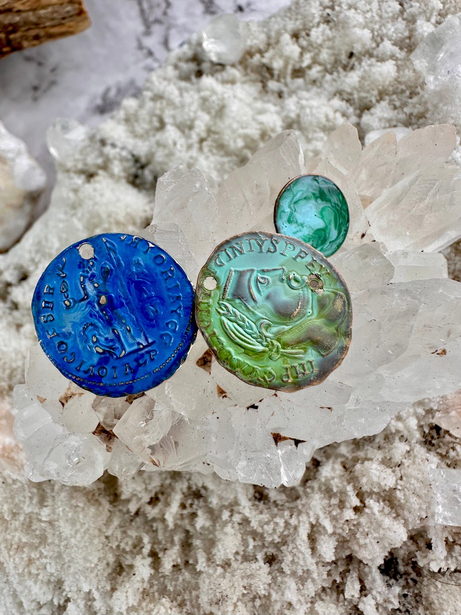 Handmade blue & green art coins on quartz crystal.