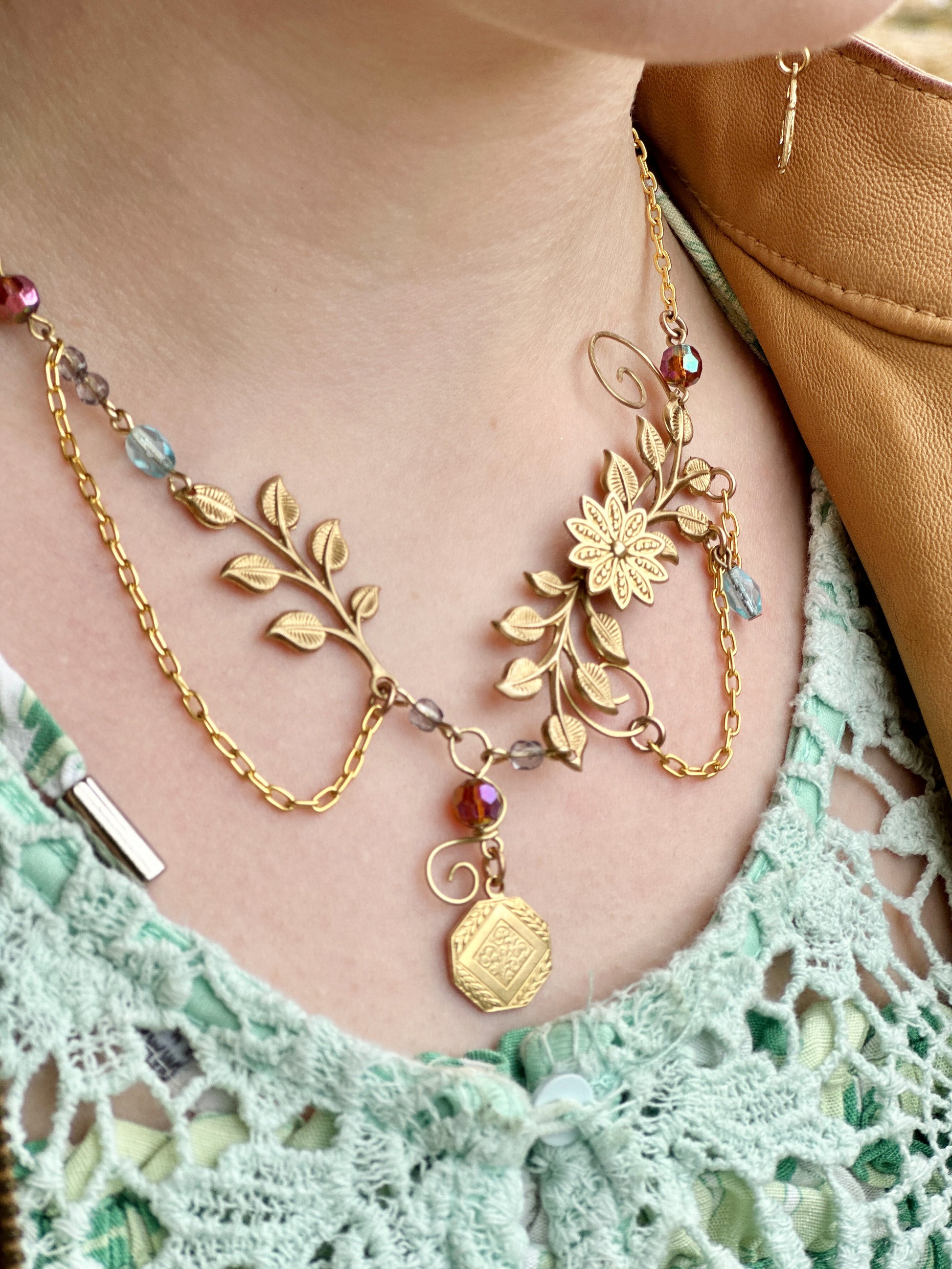 Golden floral necklace on a person's neck