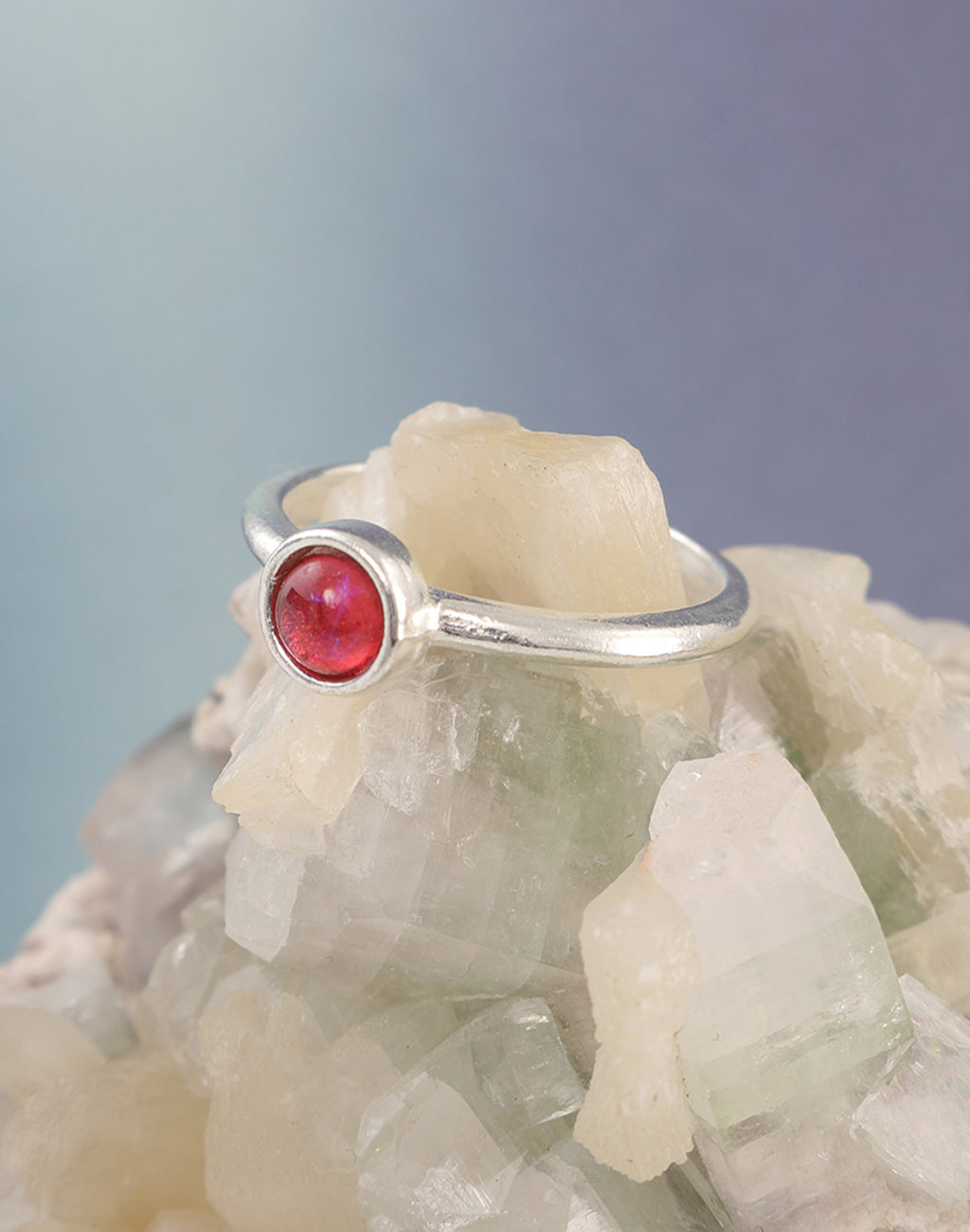 Fire opal ring on a rock