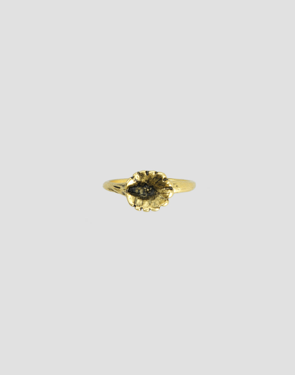 Side view of gold ring with textured band and stone