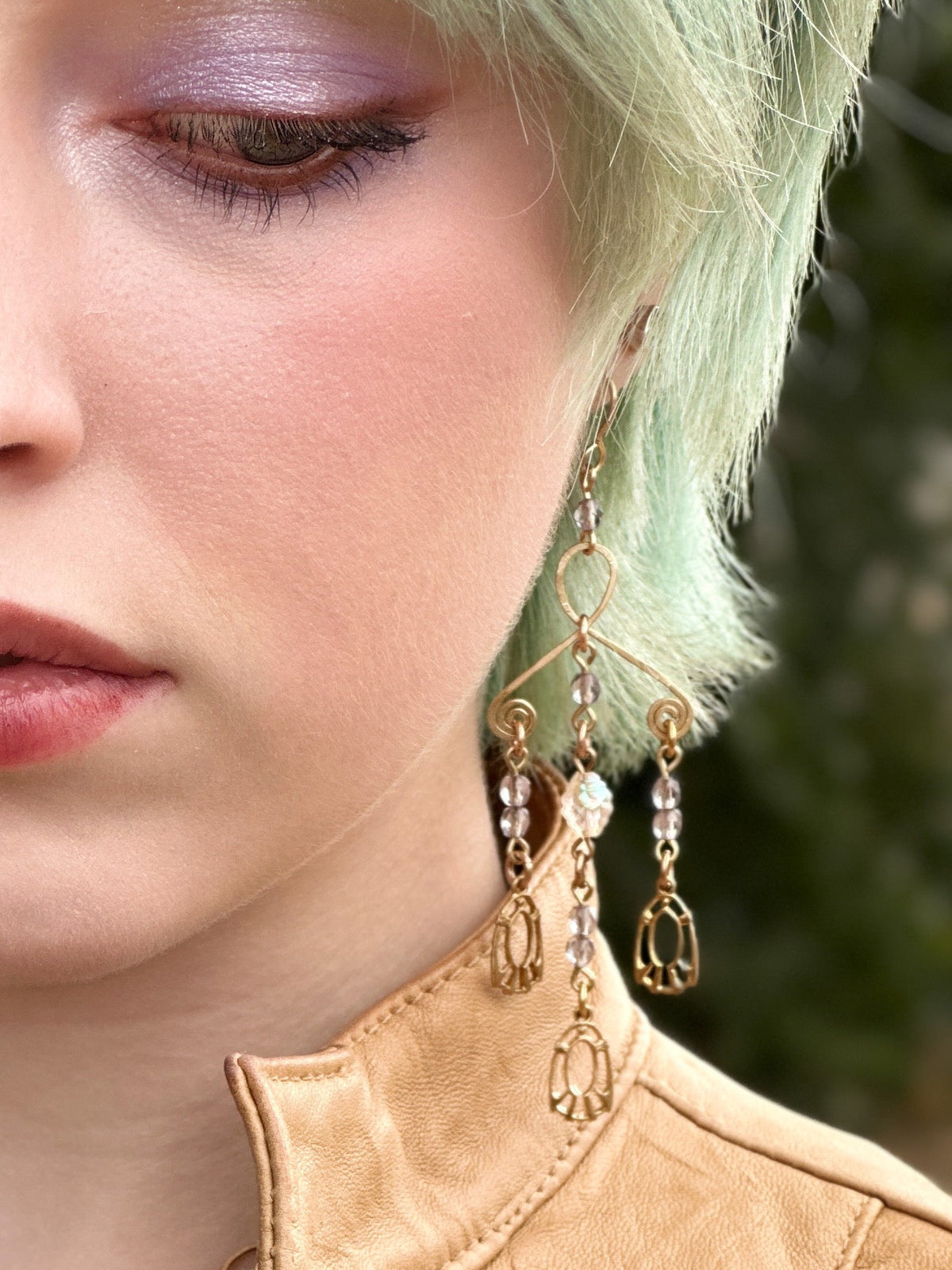 Woman wearing gold earrings, 043AAA64-9BCF-4A6C-BE2B-4742AD998EFE