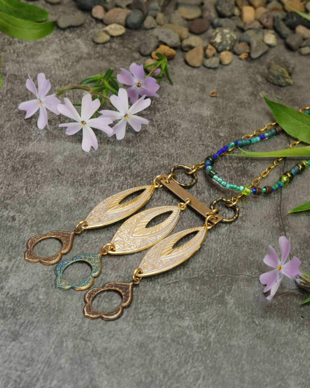 Gold leaf pendant necklace with floral accents