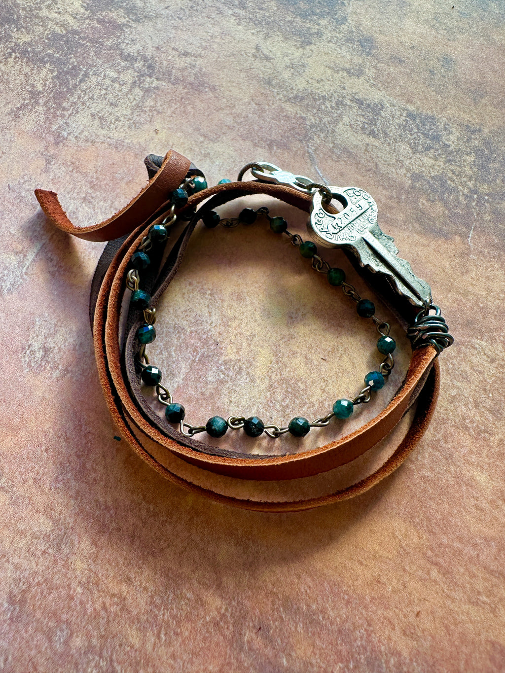 Leather wrap bracelet with key charm.