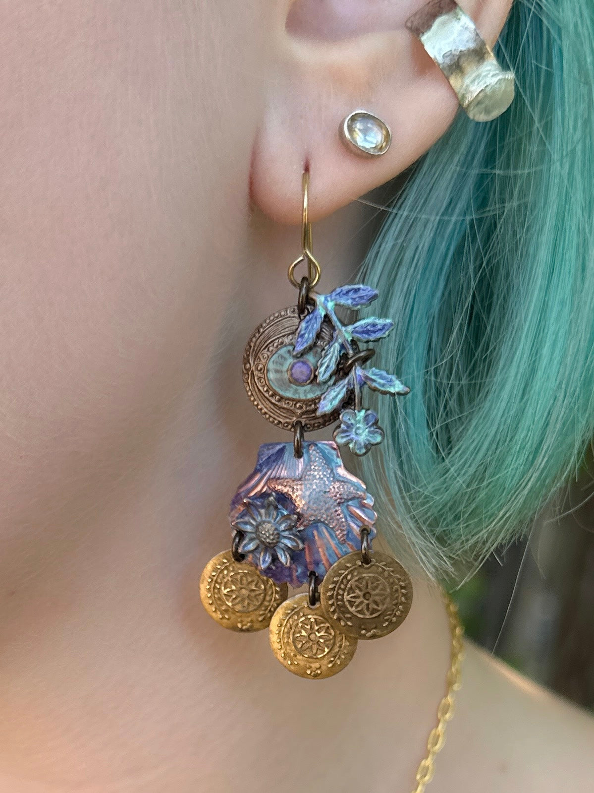 Unique handmade earrings (85DF66AE) with floral and coin details.