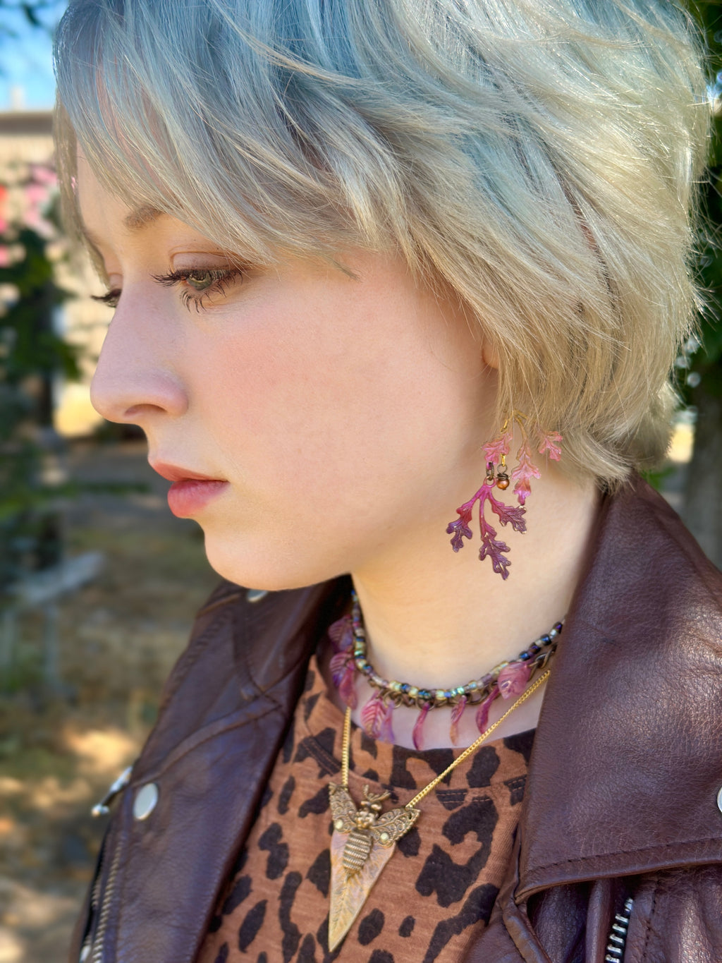 Woman with pink earrings and jewelry