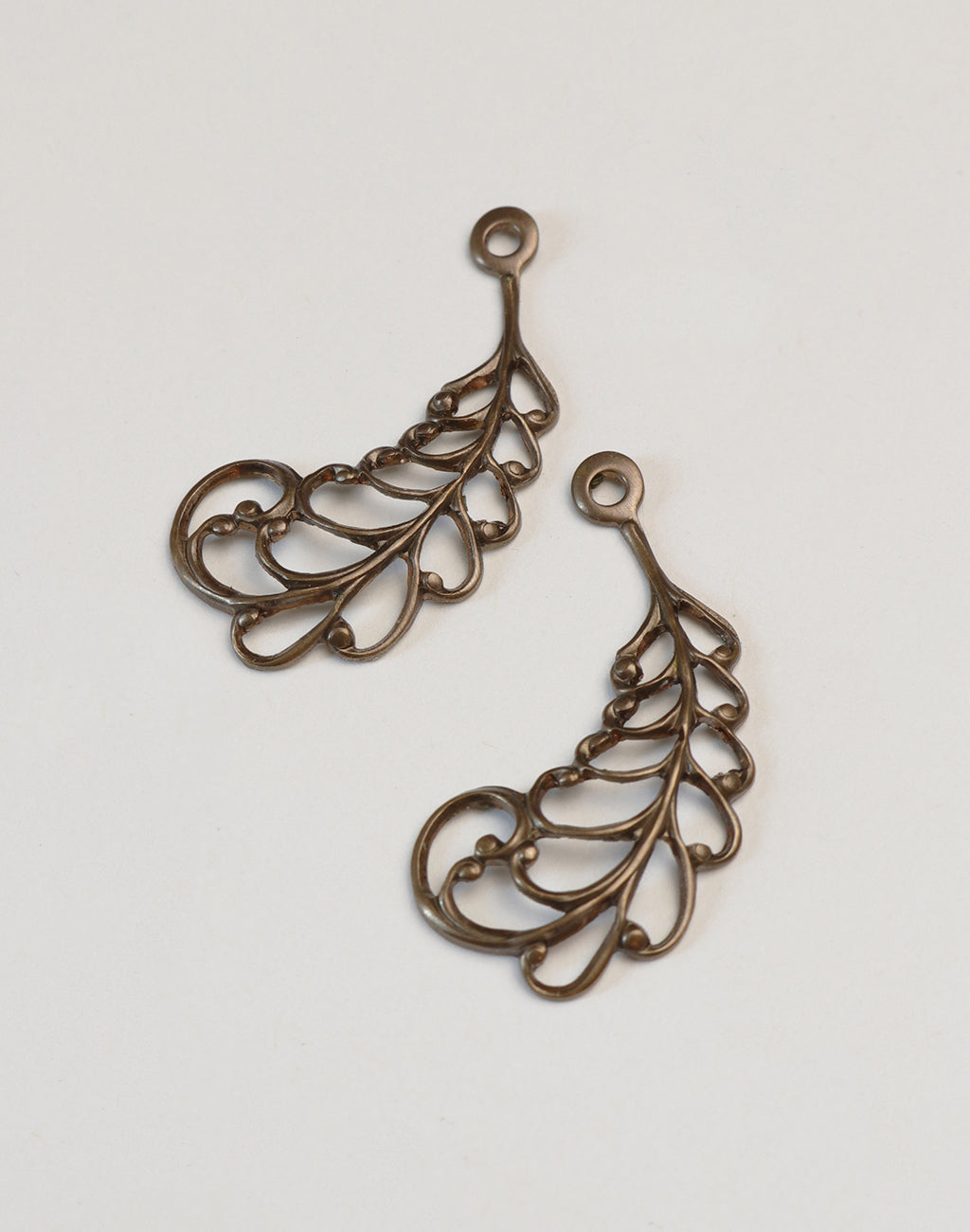 Pair of bronze filigree leaf pendants