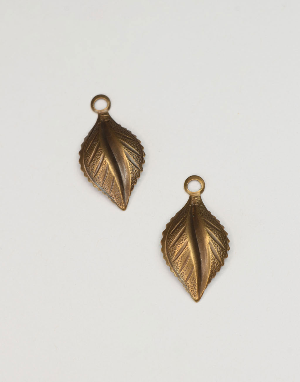 Pair of brass leaf charms