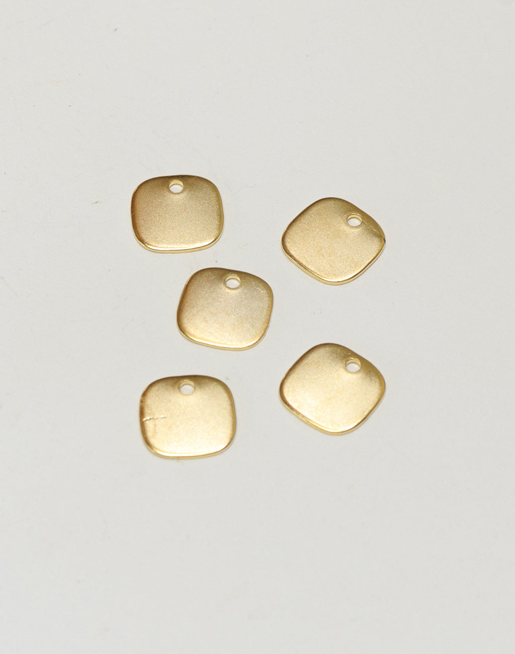 Five gold square charms with hole