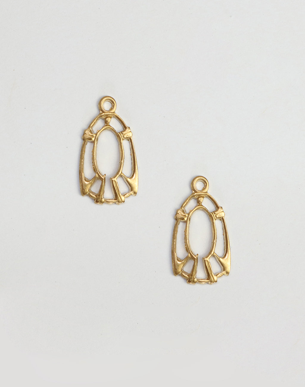 Two gold filigree pendant charms on white background