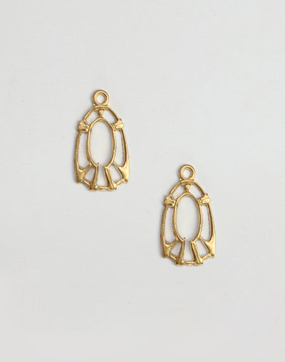 Two gold filigree pendant charms on white background