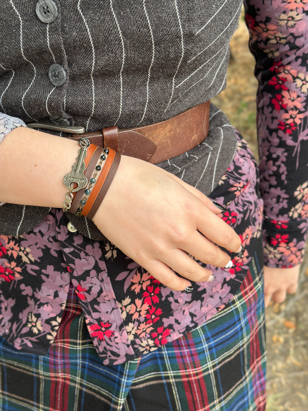 Woman wearing key bracelet and floral top