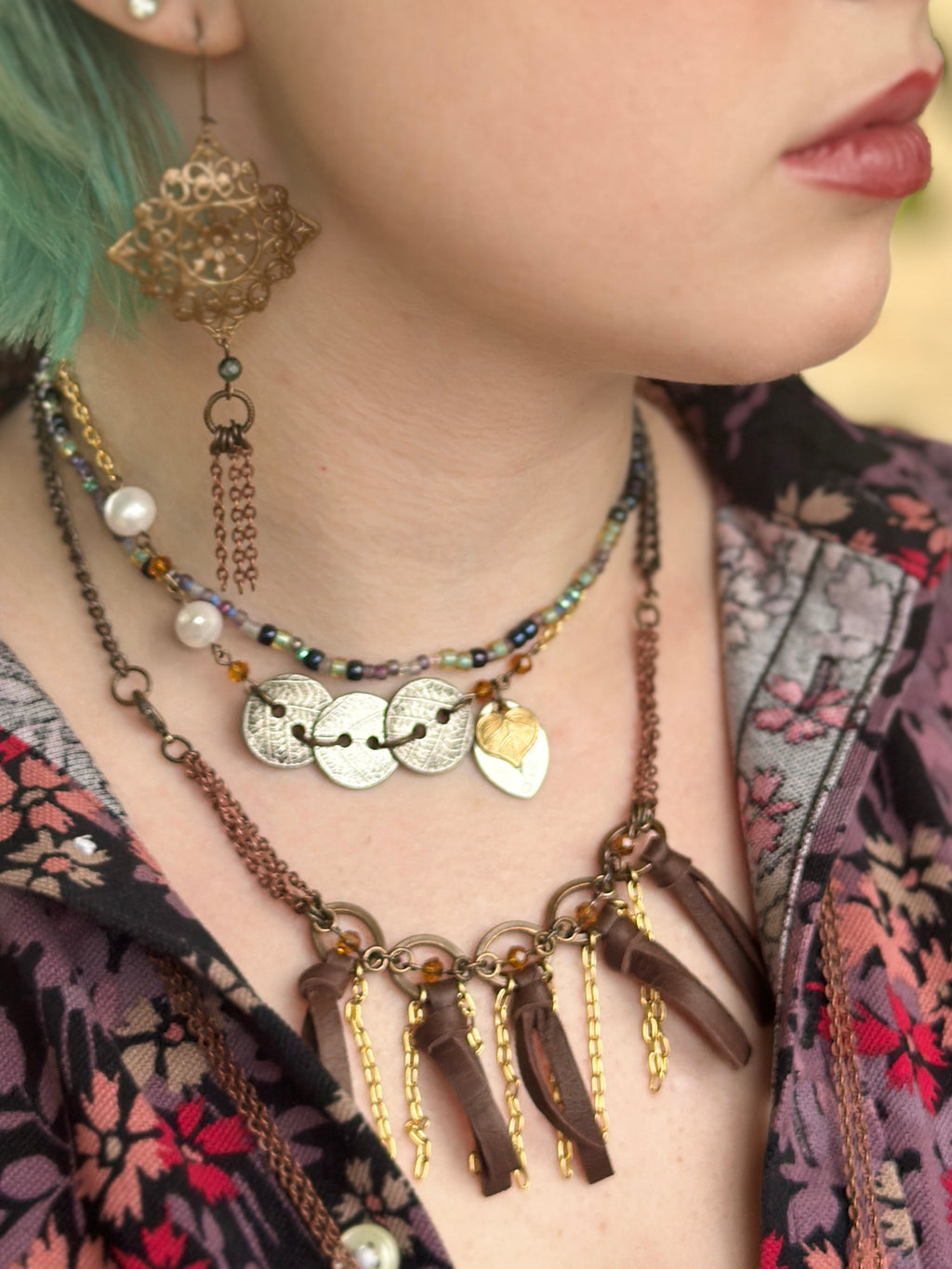 Woman wearing layered vintage jewelry