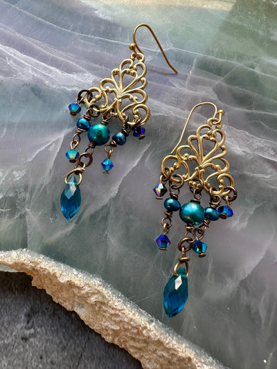 Gold chandelier earrings with blue gems