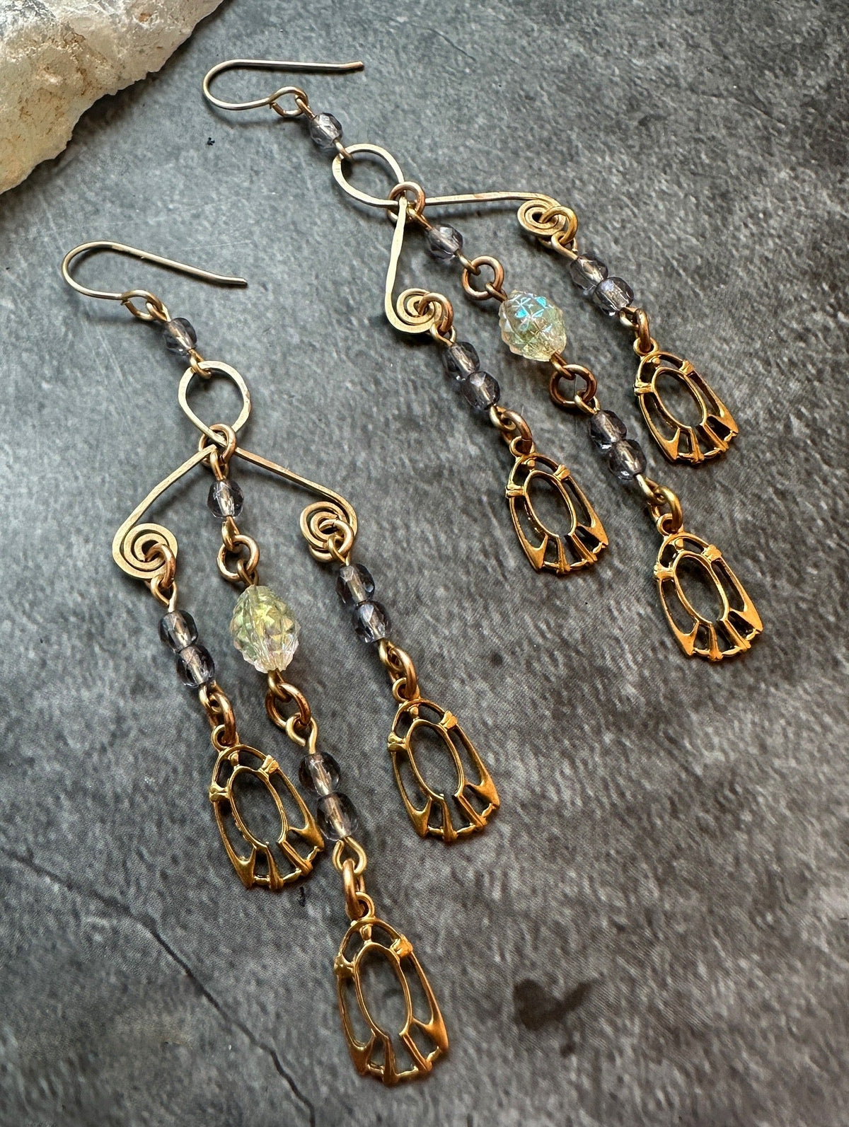 Gold dangling earrings with beads.