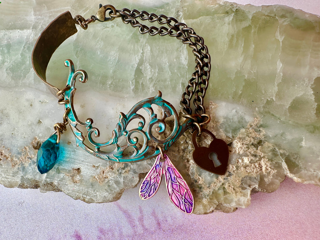 Bracelet with charms on a textured surface.