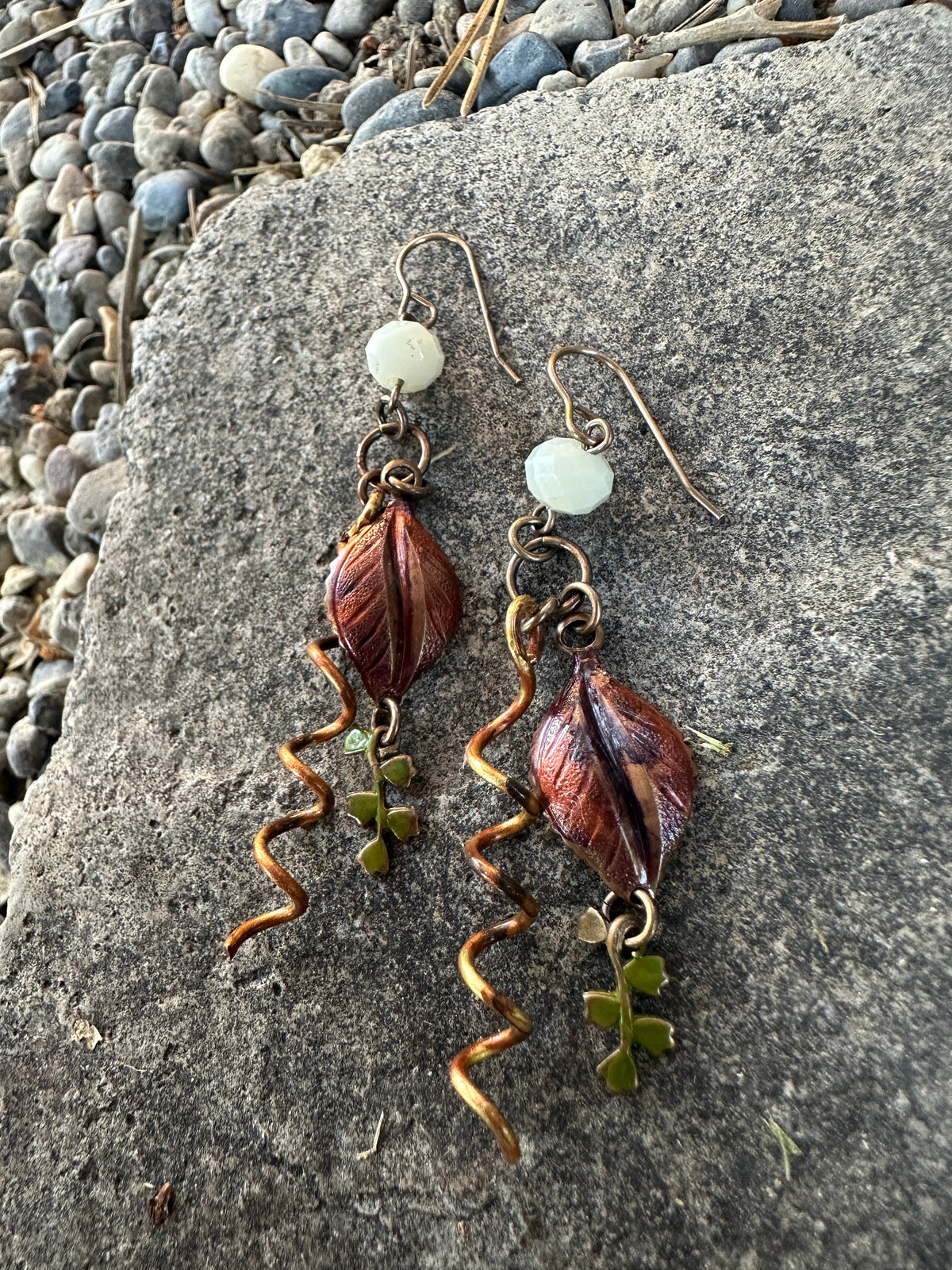 Copper leaf earrings with green accents.