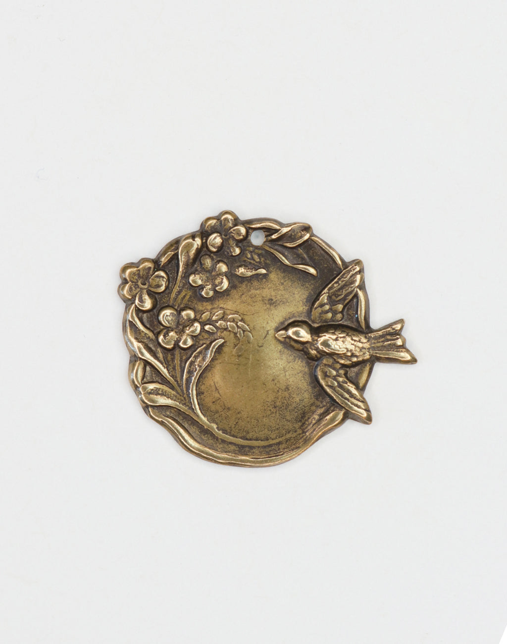Bronze bird and floral medallion.
