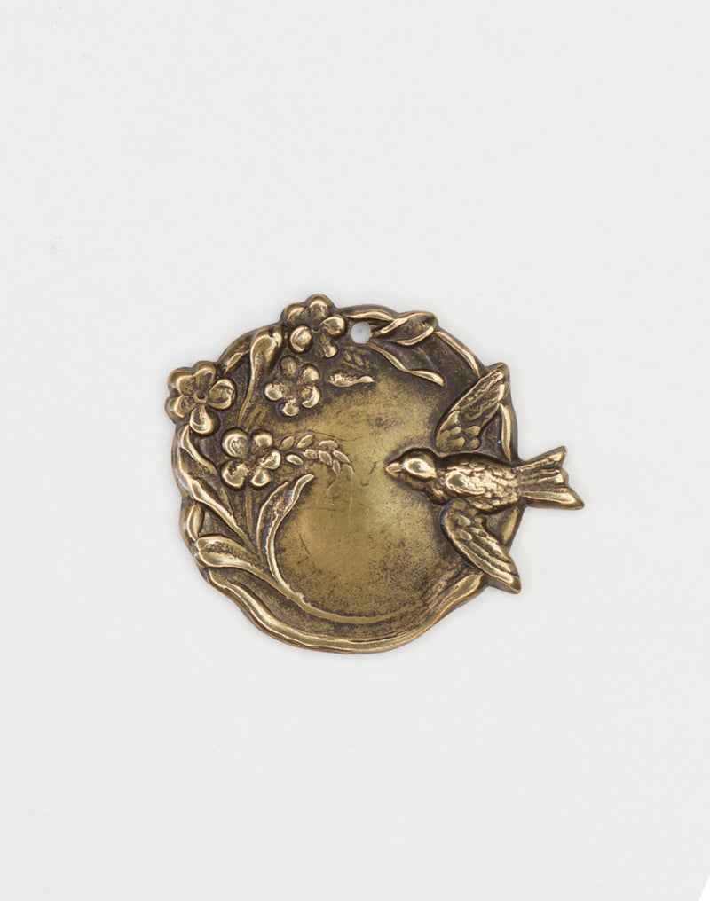 Bronze bird and floral medallion.