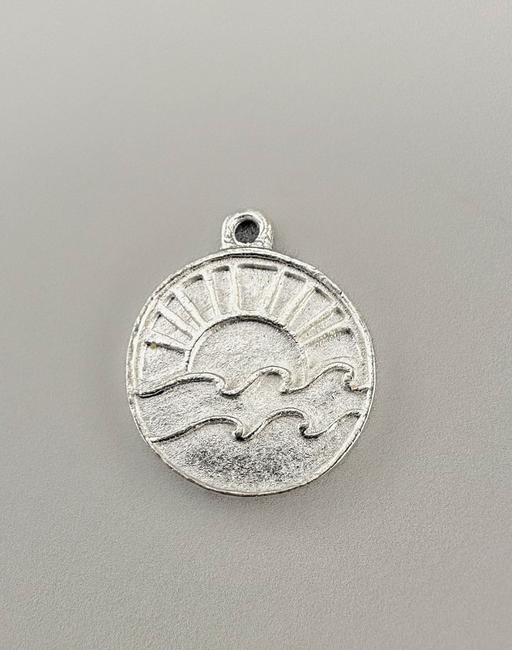 Silver Sun and Wave Charm