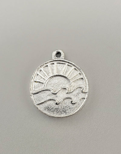 Silver Sun and Wave Charm