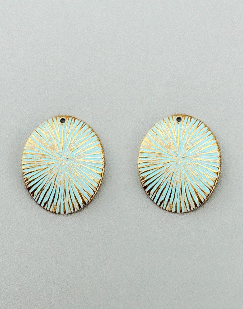 Light blue oval earrings with gold accents