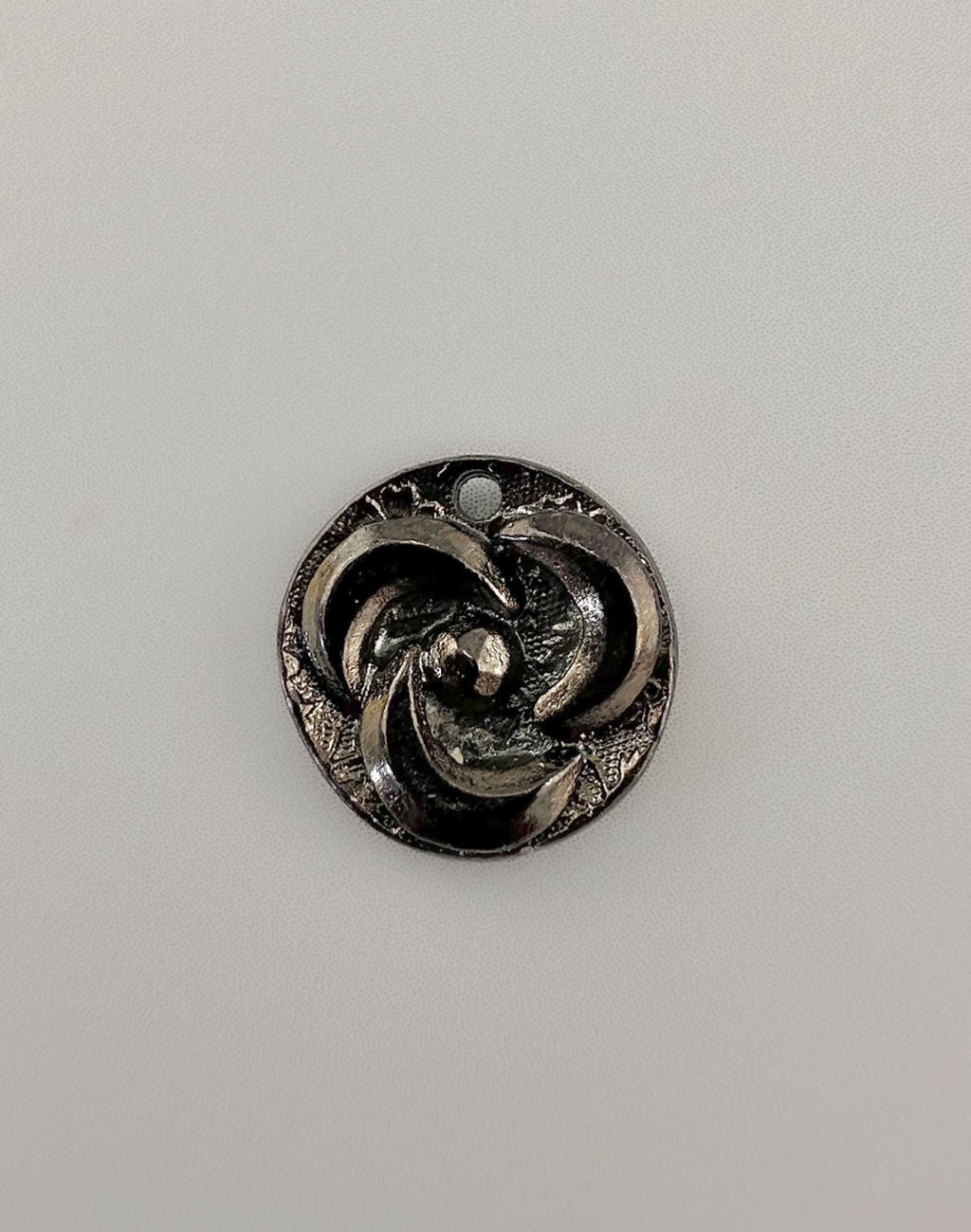 Silver pendant with spiral design