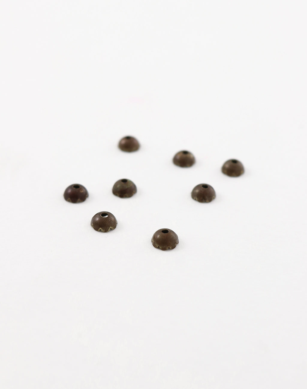 BC70 Brown bead caps on white background