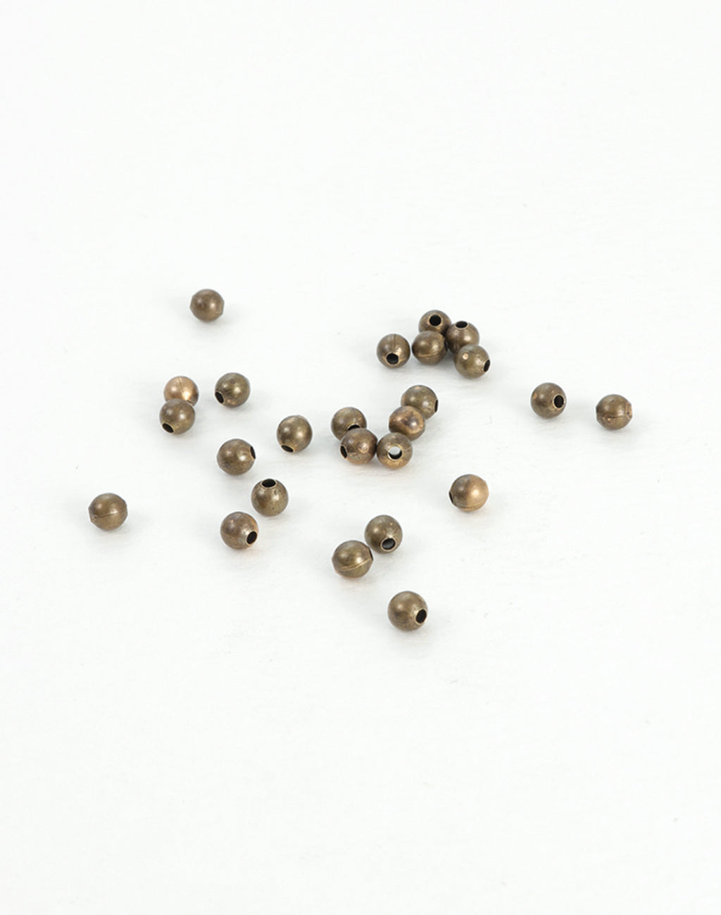 BD241 bronze beads scattered on white surface
