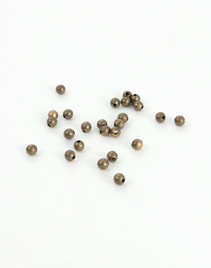 BD241 bronze beads scattered on white surface