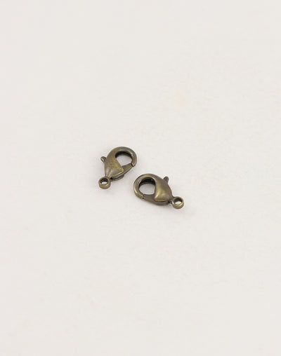 Two bronze lobster clasps on white background
