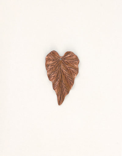 Copper leaf sculpture on white background