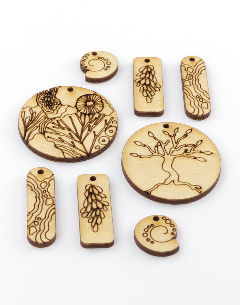 Wooden laser-cut pendants with nature designs.