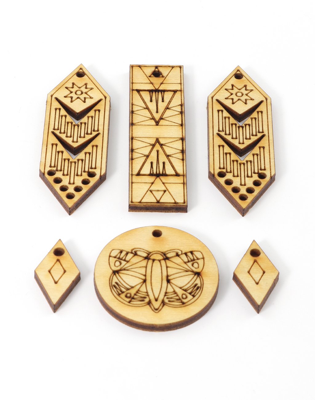 Laser-cut wooden jewelry pieces with geometric designs