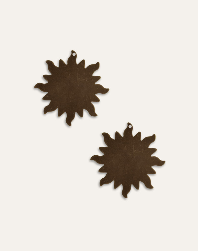 Two bronze sunburst ornaments
