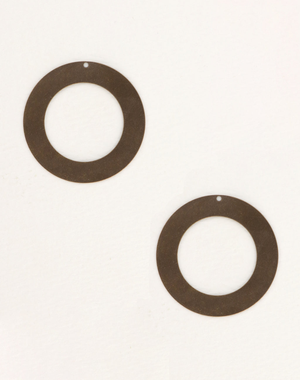 Two brown circular earrings on white background