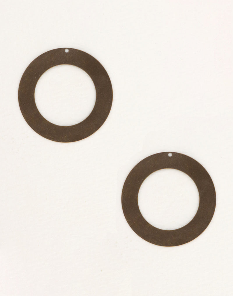 Two brown circular earrings on white background