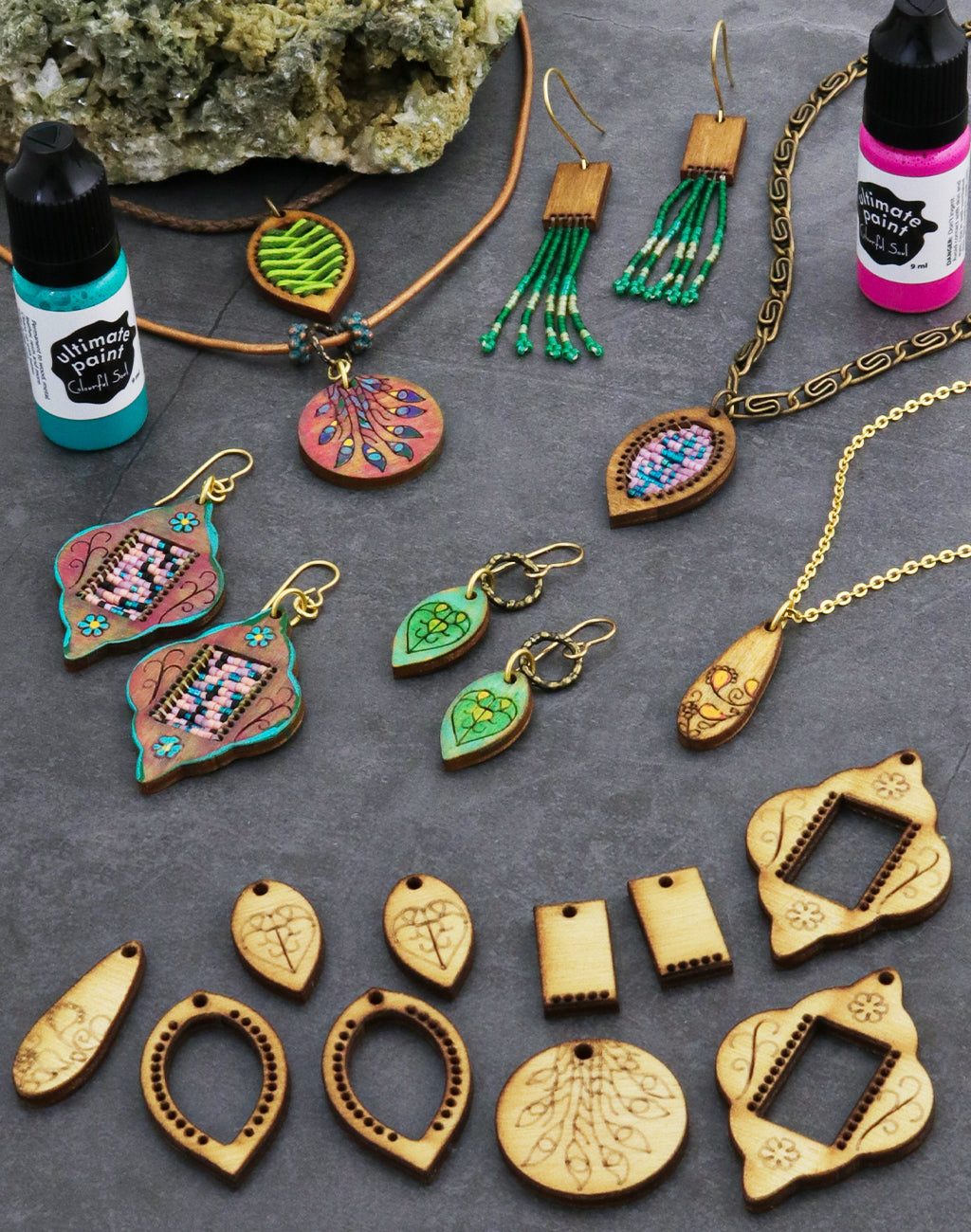 Assorted wooden jewelry and paint bottles
