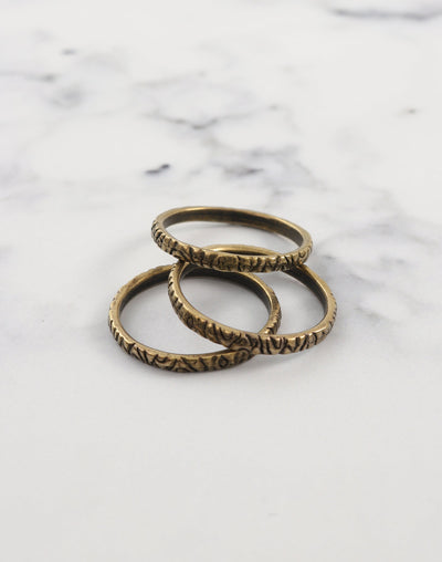 Three bronze rings on white marble
