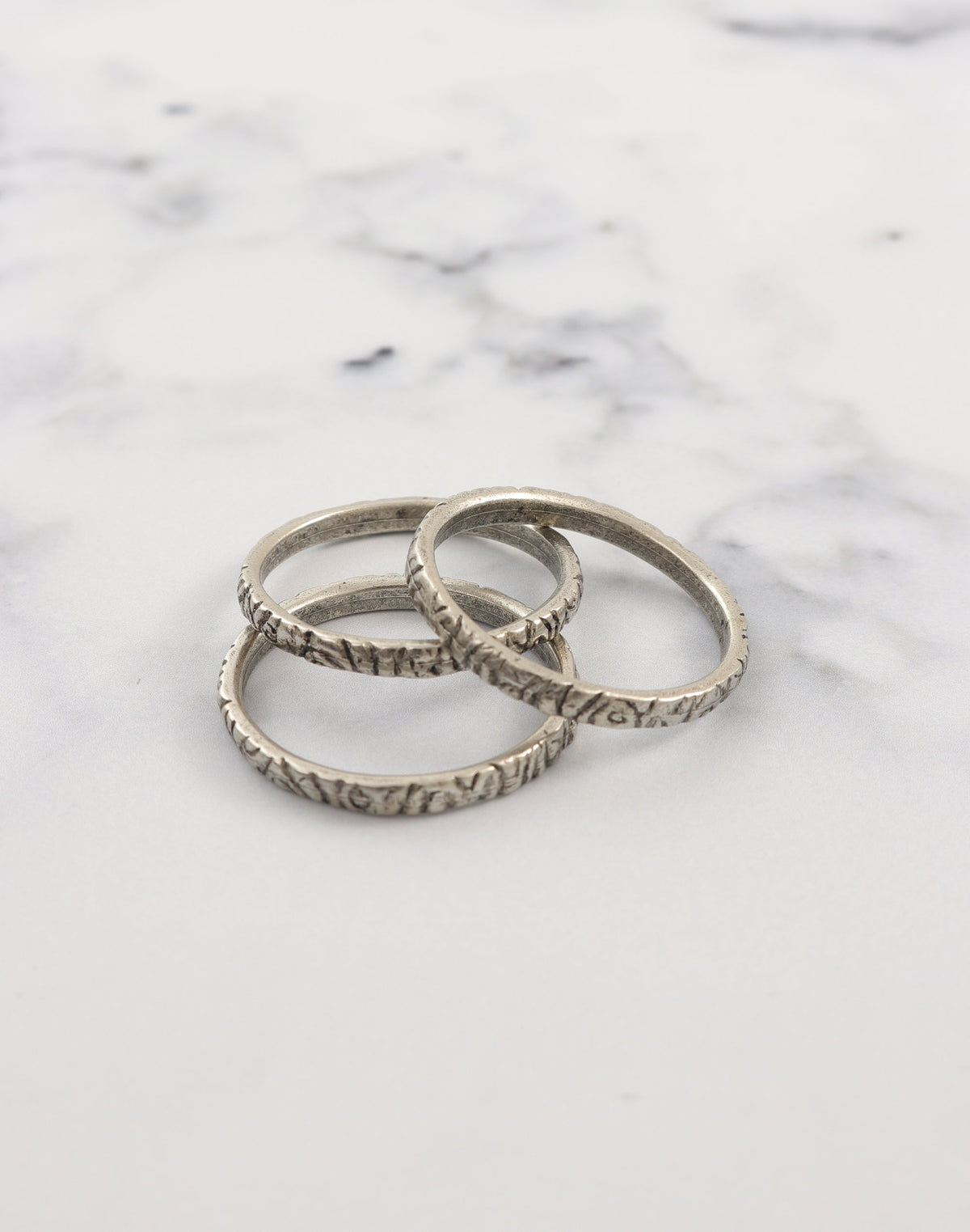 Pewter stacking rings on marble
