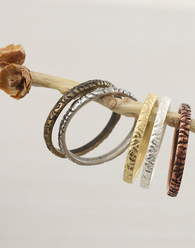 Stack rings in various metals on branch