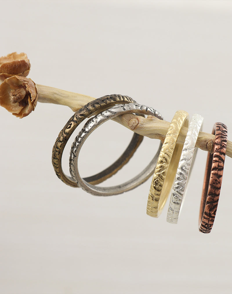 Stack rings in various metals on branch