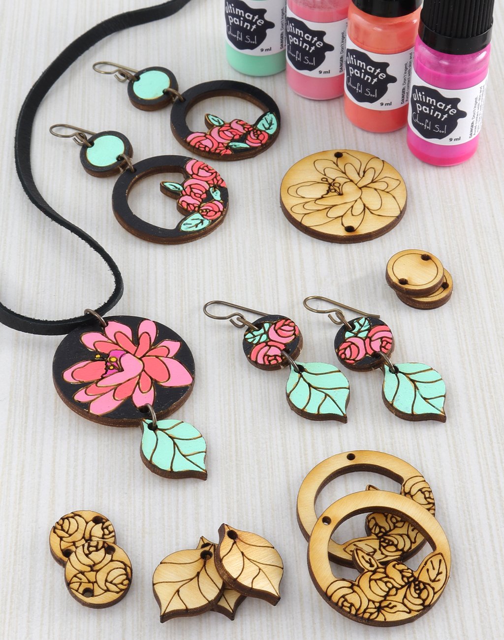 Wooden jewelry with patina and pink floral designs
