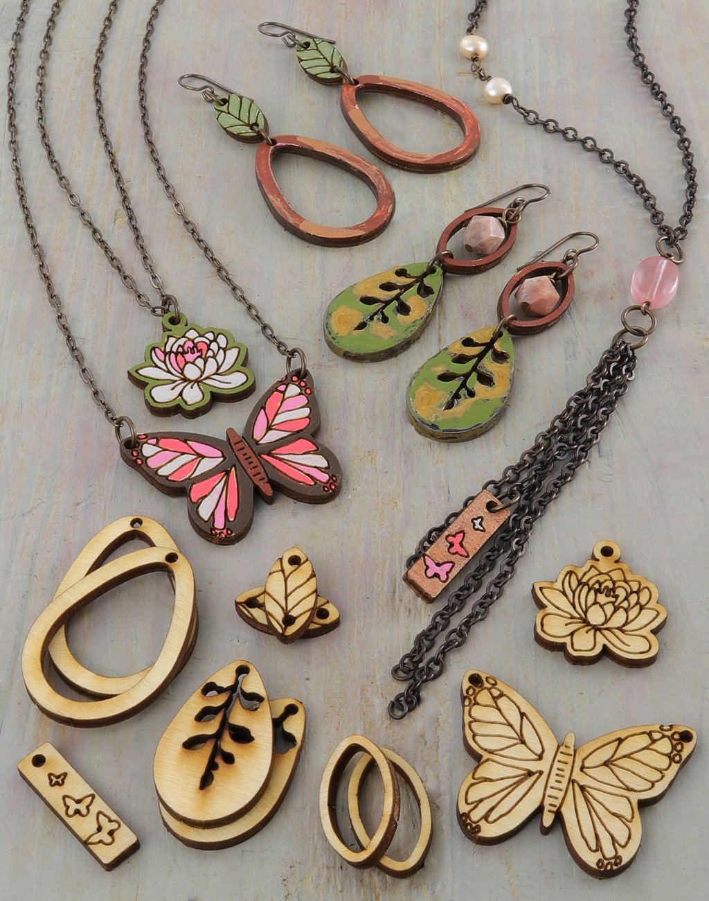 Wooden necklaces and earrings with floral & butterfly designs.
